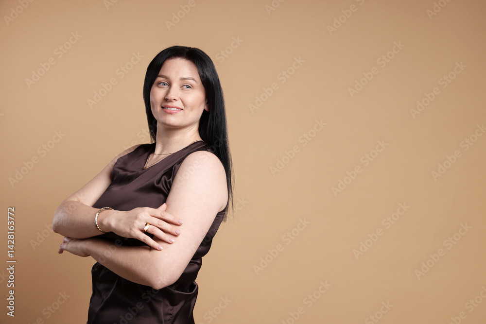 Obraz premium Portrait of smiling plus size model on beige background, space for text. Overweight