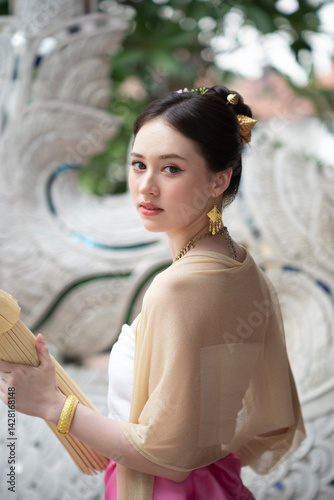 Obraz na płótnie Beautiful young Asean woman in traditional Thai Dvaravati dress in an old temple in Chiang Mai, Thailand. w salonie