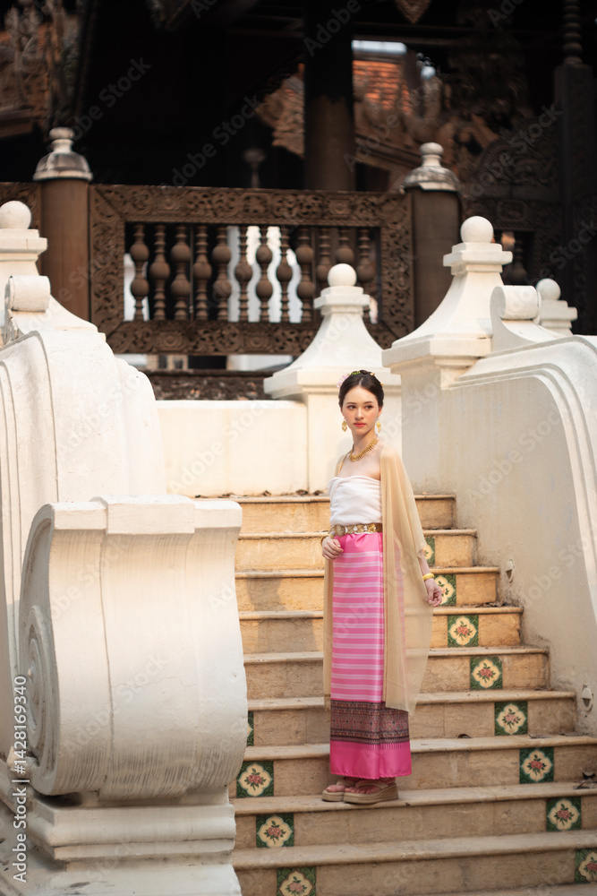 Beautiful young Asean woman in traditional Thai Dvaravati dress in an old temple in Chiang Mai, Thailand.