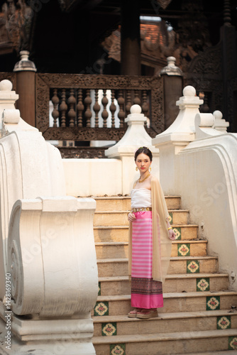 Obraz na płótnie Beautiful young Asean woman in traditional Thai Dvaravati dress in an old temple in Chiang Mai, Thailand. w salonie
