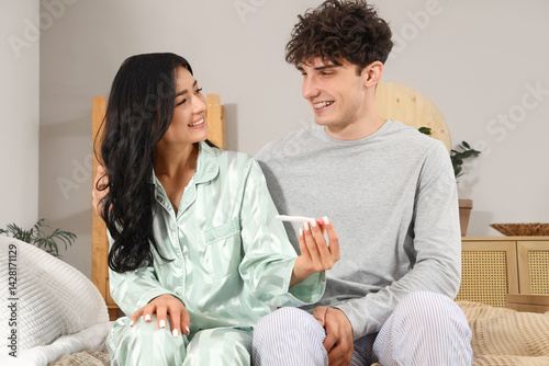 Happy young couple with pre...