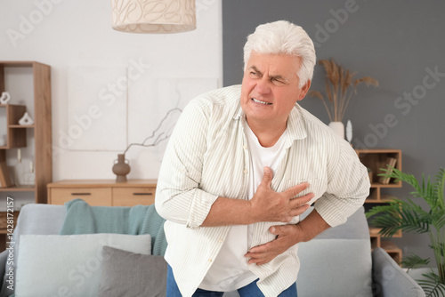 Mature man having heart att...