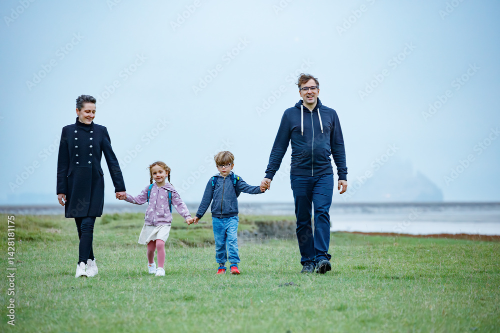 Parents and kids share fun outdoor stroll together in France