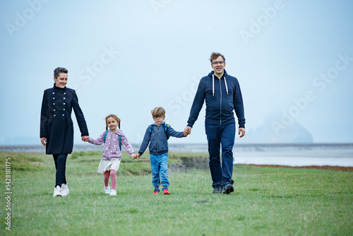 Obraz na płótnie Parents and kids share fun outdoor stroll together in France w salonie