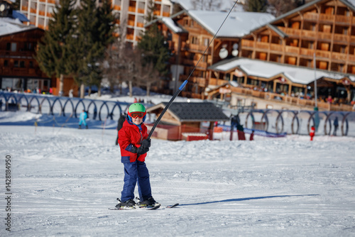 Obraz na płótnie Child ski in colorful attire among breathtaking snowy mountains w salonie