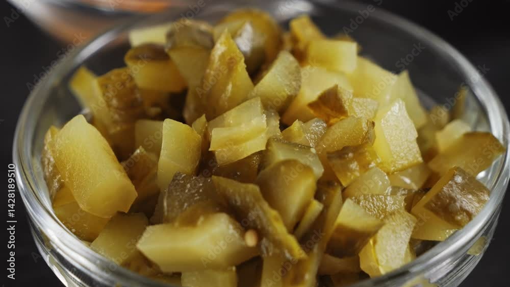Finely chopped pickled cucumbers in a bowl, ready ingredient for salads. High quality 4k footage Finely chopped pickled cucumbers in a bowl, ready ingredient for salads. High quality 4k footage