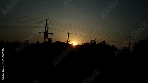 An epic view of a dark sunset over fields as seen from a speeding train.moving train and sunset