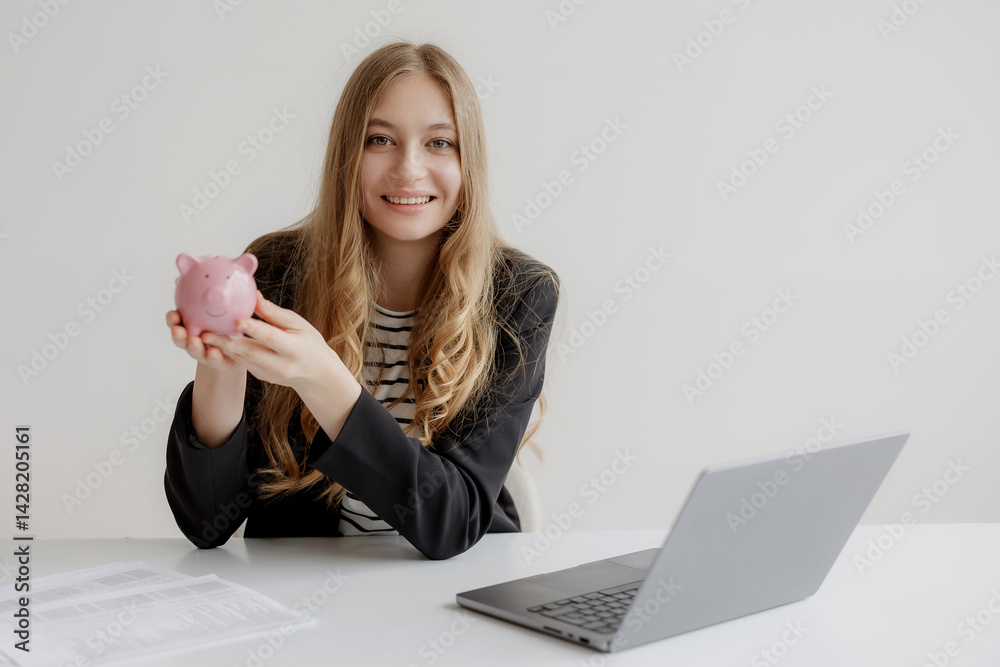 Young woman with piggy bank discusses financial savings at home office desk