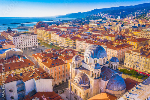 A unique aerial view of city center landmarks in Trieste, Italy, capturing the church’s striking domes, elegant architecture, and the surrounding urban landscape of this Adriatic city photo