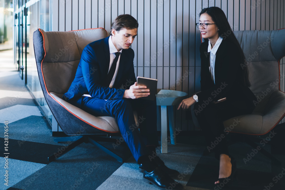 Full length portrait of diverse employees looking at camera while experienced colleagues using 4g wireless on modern touch pad for making web banking, multiracial partners collaborating in office
