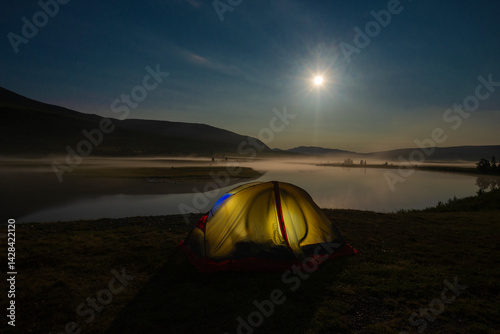 Tourist tent on the bank of the Longotyegan river on a polar night. Yamal, Russia