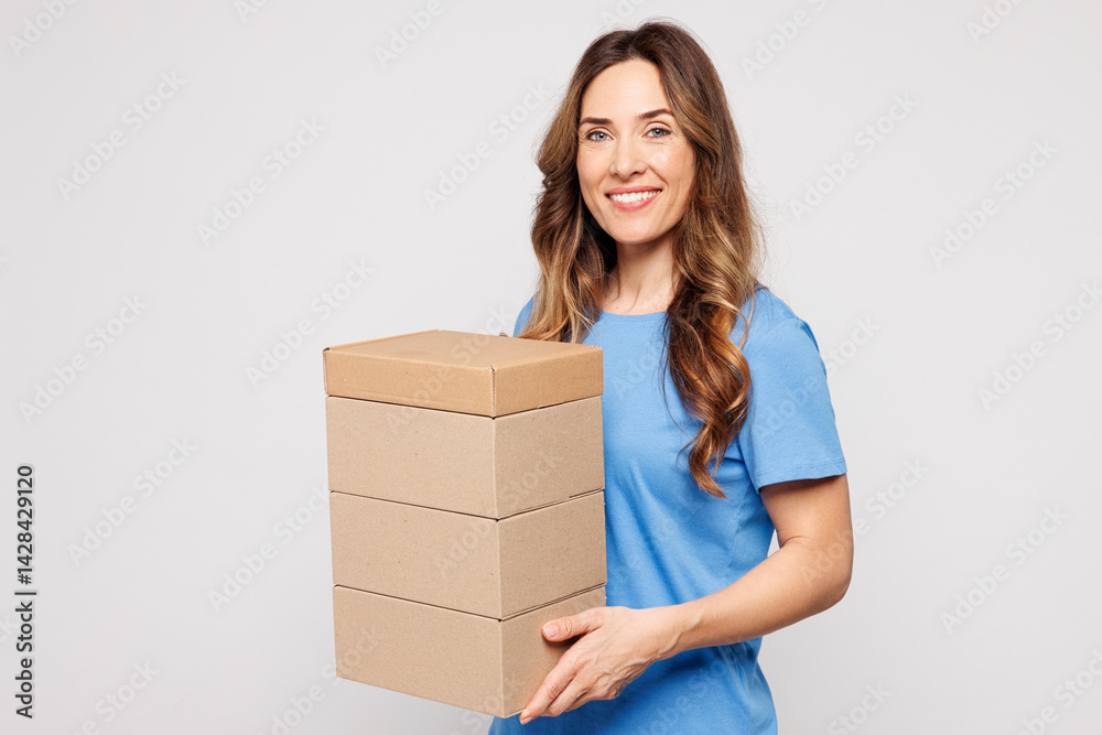 Side view young smiling happy Caucasian woman she wears blue t-shirt casual clothes hold stack cardboard blank boxes isolated on plain solid white color background studio portrait. Lifestyle concept. Side view young smiling happy Caucasian woman she wears blue t-shirt casual clothes hold stack cardboard blank boxes isolated on plain solid white color background studio portrait. Lifestyle concept.