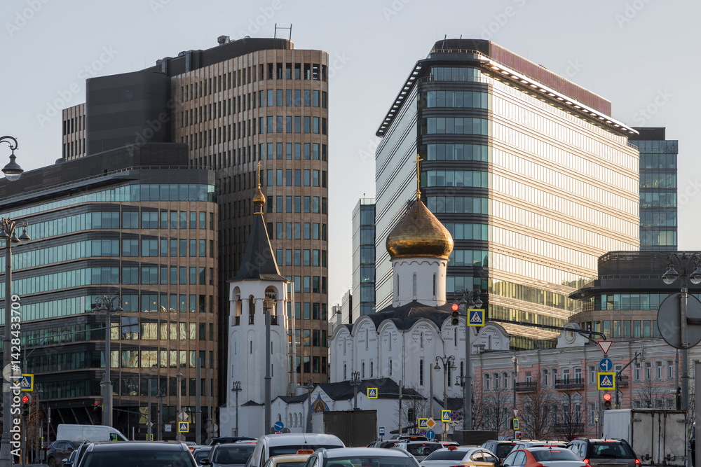Cityscape with a church against the backdrop of modern office buildings. Traditional and modern architecture in a big city. Contrast of old and new. Moscow, Russia.