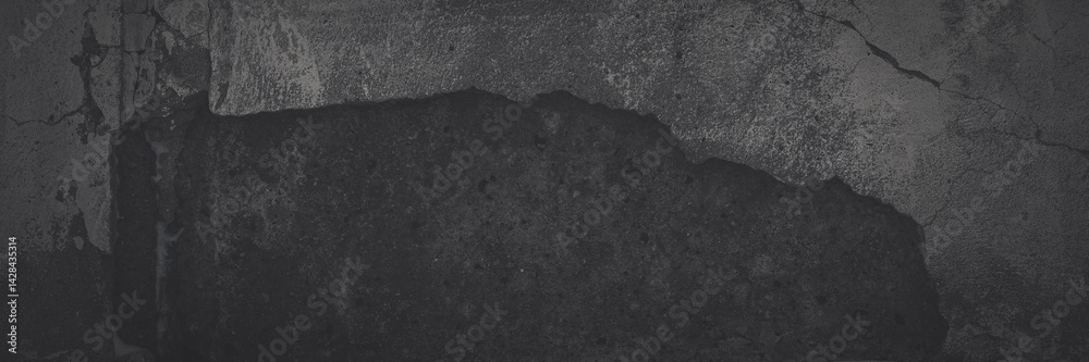 Texture of old cracked concrete wall. Rough faded dark gray concrete surface with spots, cracks, noise and grain. Dark wide panoramic background for grunge style design. Shaded texture with vignette.