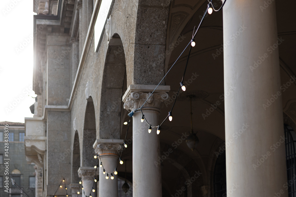 Decorative vintage street black light bulbs with white shade. Outdoor Street electric garland. Old light bulbs. String wired bulbs. Festoon string lights decoration at the party event.