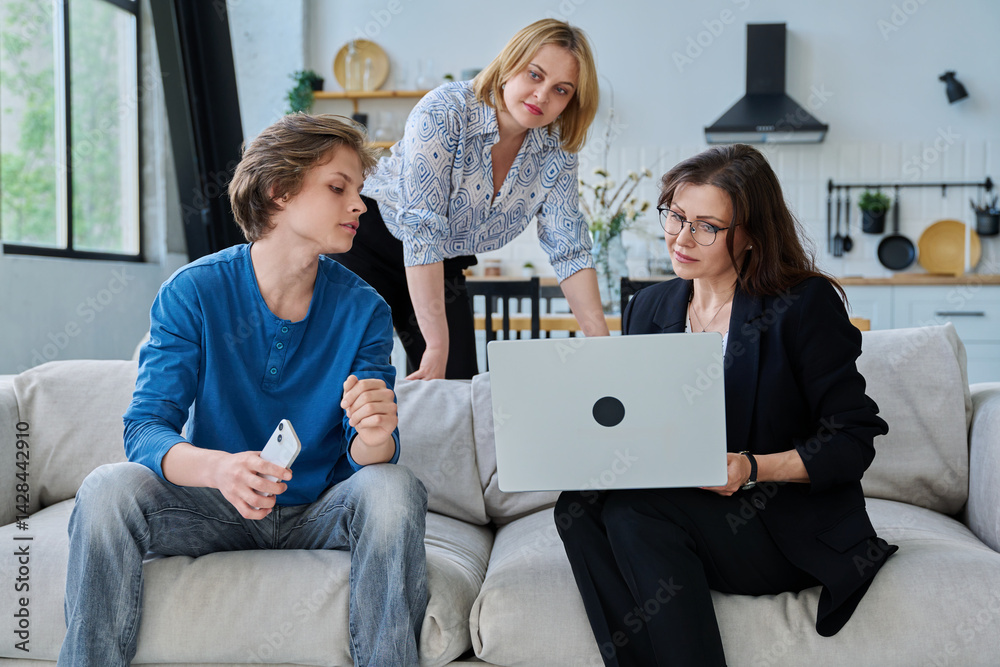 Family, mother and teenage son meeting with social worker sitting on couch at home