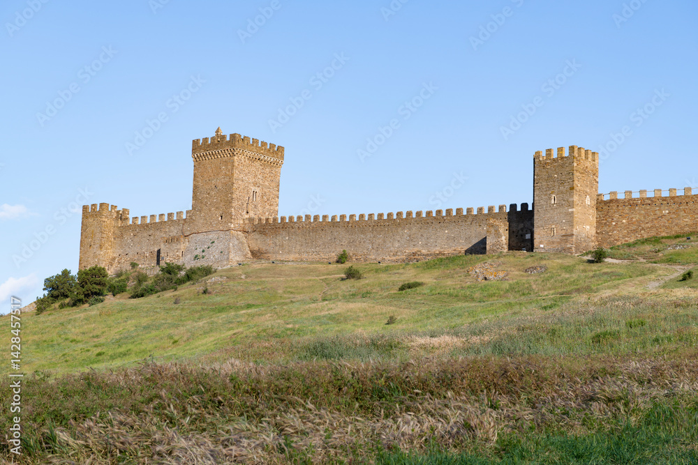 View of the ancient towers of the Consular Castle of the medieval Genoese fortress on a sunny May day. Sudak, Crimea