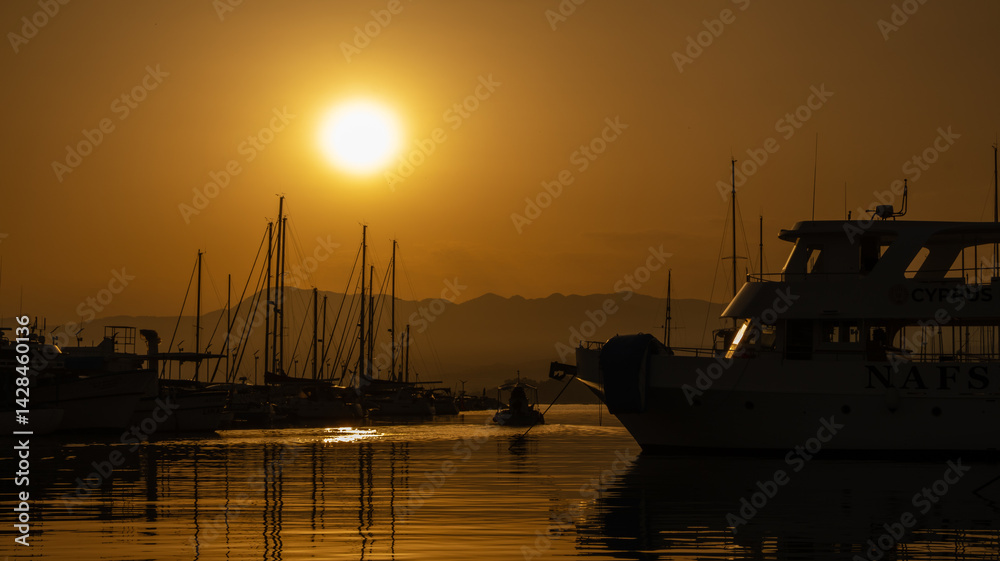 Fototapeta premium The harbour of Latchi in orange colour when the sun is rising