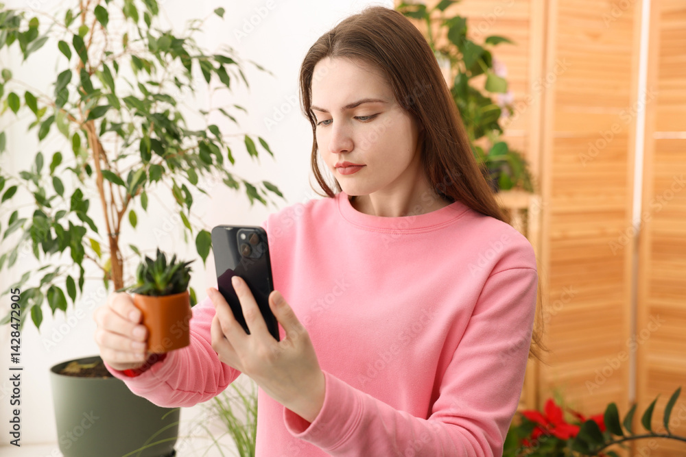 Woman using houseplant recognition application on smartphone indoors Woman using houseplant recognition application on smartphone indoors