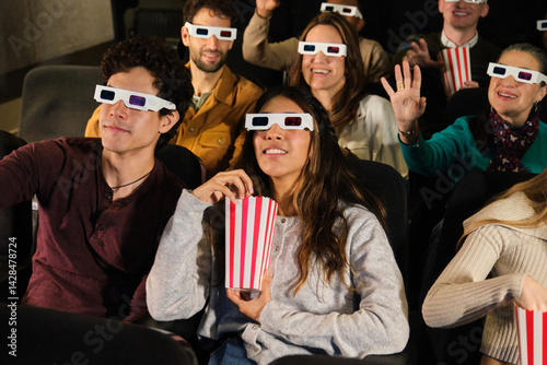 Obraz na płótnie Friends enjoying a 3d movie together at the cinema, wearing 3d glasses and eating popcorn w salonie