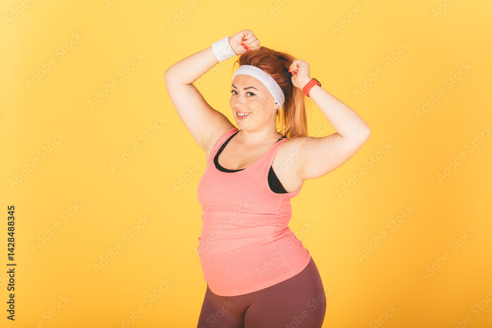 A woman in a pink tank top and black shorts is posing for a picture