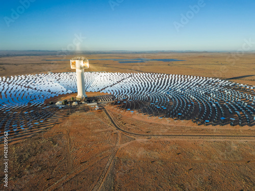 Solar rays reflect off grid of mirrors onto concentrated solar tower in Kalahari desert near Upington, South Africa