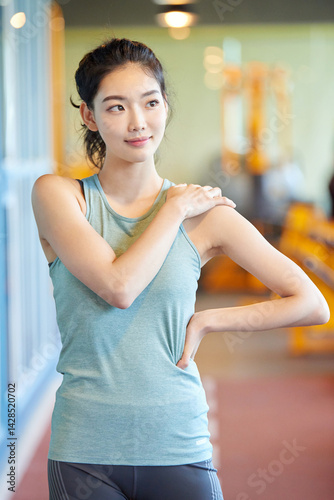 Asian Woman Stretching Arm at Gym Free Download Asian Woman Stretching Arm at Gym - GFXLoad