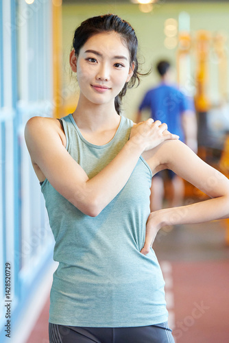 Asian Woman Stretching Arm at Gym Free Download Asian Woman Stretching Arm at Gym - GFXLoad