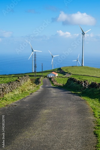 Obraz na płótnie Modern wind turbines on the verdant hills of Serra do Cume with a sweeping vista of Terceira Island. The image captures the renewable energy technology with the natural beauty of the Azores landscape w salonie