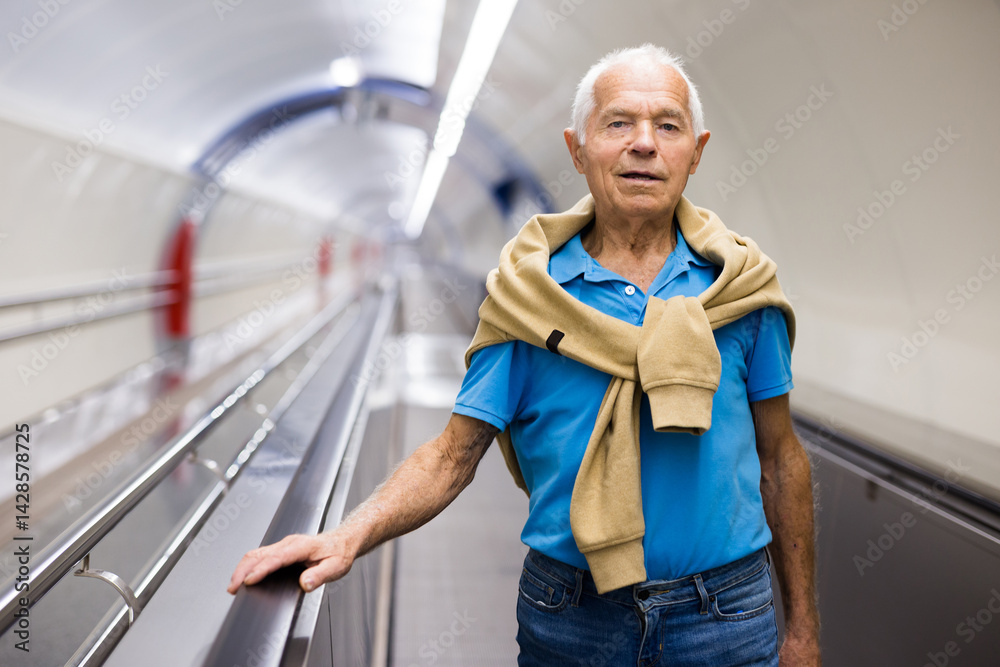 Old man standing on travolator