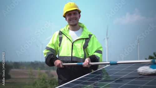 worker with orange helmet at solar panel generator solar power generator plant construction background. solar cell plant and wind generators in farm