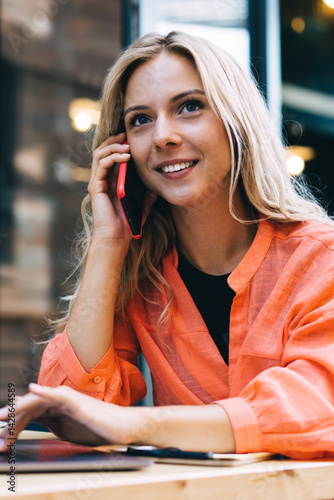 Obraz na płótnie Cheerful young businesswoman working remotely in modern cafe w salonie