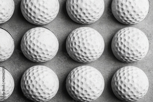 Obraz na płótnie Collection of White Golf Balls Arranged on a Concrete Surface w salonie