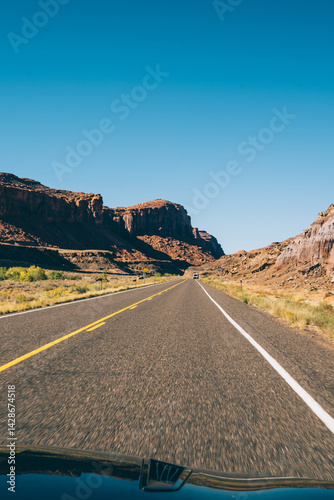 Car driving through dry rocky terrain in USA