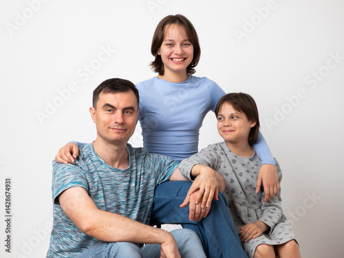 Studio portrait of family: father and daughters