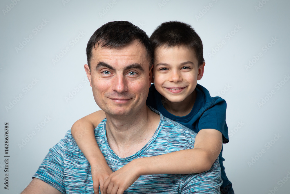 Studio portrait of family: father and son.