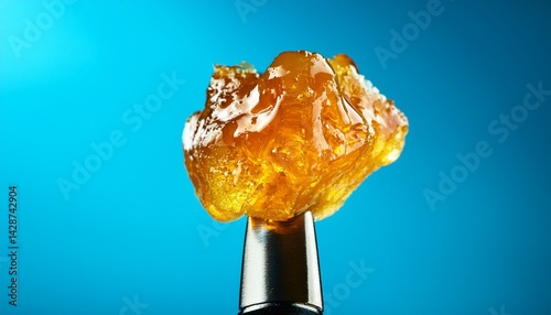 live rosin on a dab tool with a light blue background