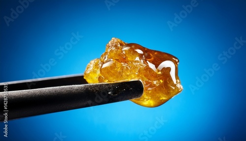 live rosin on a dab tool with a blue background
