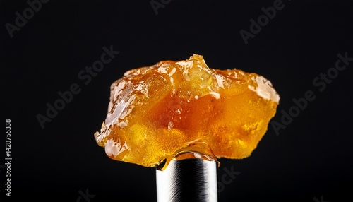 live rosin on a dab tool with a black background