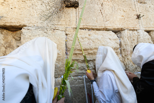 An Orthodox, Jewish man holds the four species lulav - etrog or citron fruit, willow and myrtle branches and a palm frond - used in the ritual observance of the Jewish holiday of Sukkot..