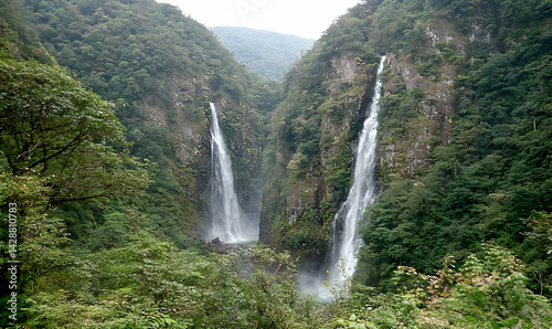 Majestic Twin Waterfalls Cascading Through Lush Green Valley