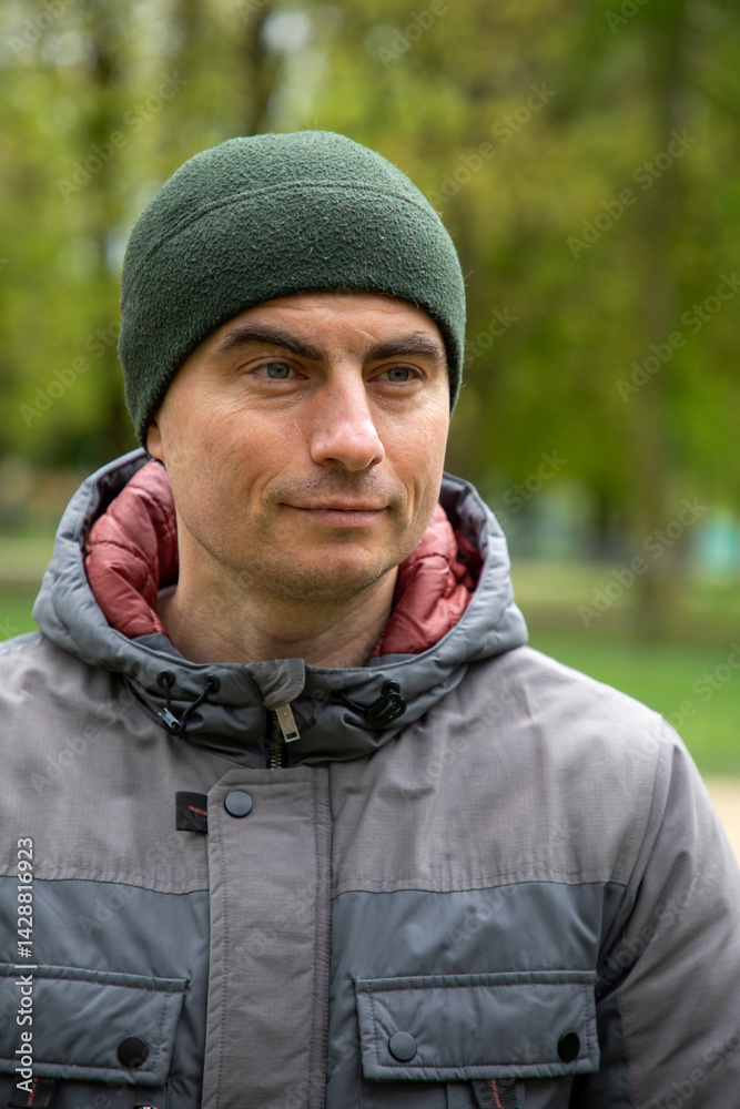 Portrait of handsome man outdoors in park in spring.