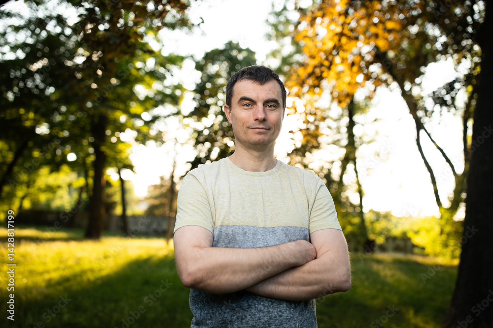 Portrait of handsome man outdoors in park in spring.