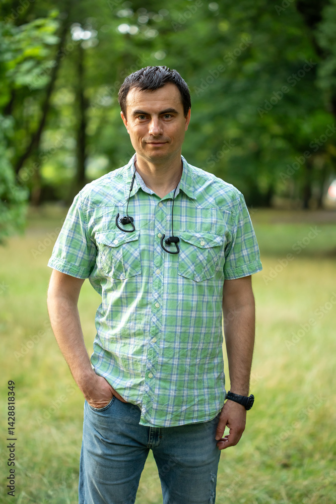Portrait of handsome man outdoors in park in spring.