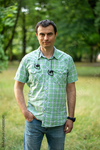 Obraz na płótnie Portrait of handsome man outdoors in park in spring. w salonie