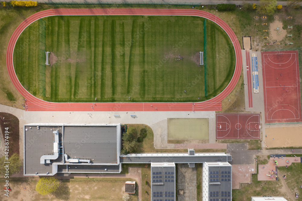School Complex with Sports Fields and Urban Landscape - Aerial View