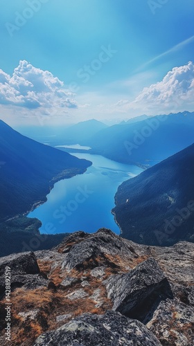 Majestic view over Slocan Valley showcasing a serene lake and mountain range under a brilliant blue sky in British Columbia photo