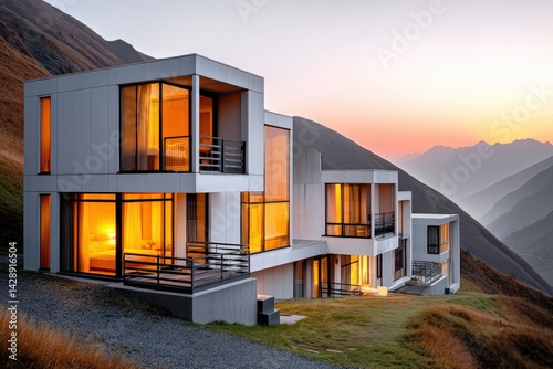 Modern Minimalist House on Hill at Sunset with Warm Glowing Windows