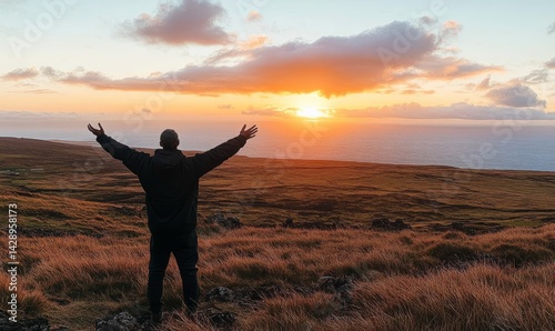 Obraz na płótnie As the sun sets over a field, a man stands there, feeling free, hopeful, and happy, appreciating the beauty of life w salonie