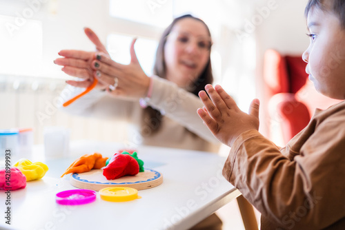 Εκτύπωση καμβά Childcare provider and toddler playing with modeling clay, developing fine motor